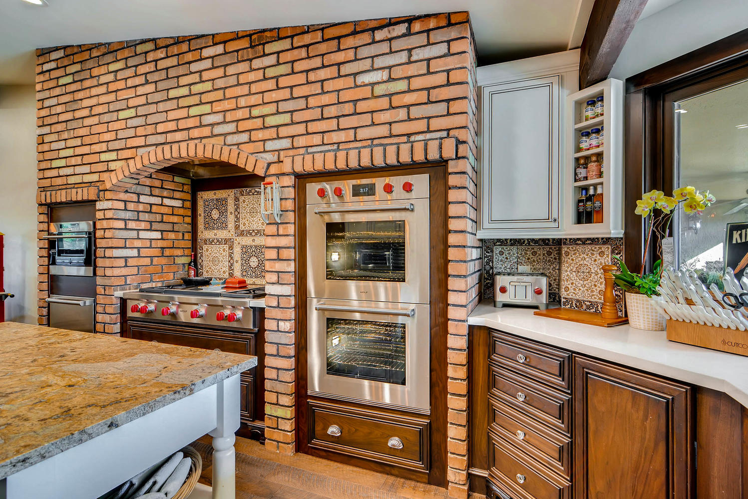 Brick arch kitchen with double wall ovens